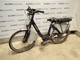 bicycle parked in front of a wall with a sign in the background