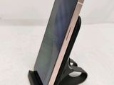 a cell phone that is on a stand on the table
