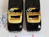 two black and gold cell phones sitting next to each other