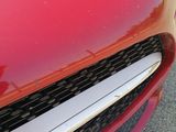 a close up of a red car with chrome trims