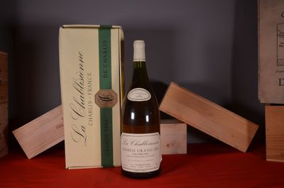 a bottle of wine sitting on a table next to a box of wine
