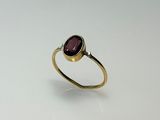 a gold ring with a garnetite stone in the center