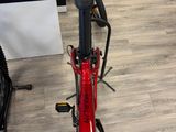 a red bicycle that is sitting on the floor