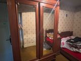 a bedroom with a bed and a closet in it