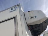 an image of a white rv parked in a parking lot