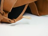 a black and brown bag with a brown strap on it