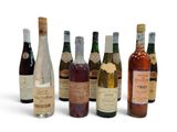 several bottles of wine are lined up in a row on a white surface