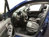 the interior of a car with the door open showing the steering wheel and dashboard