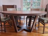 a wooden table with chairs around it in a room