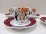 four cups and saucers on a table with red rims