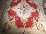 an image of a red and white rug on a tiled floor