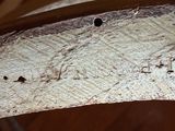 a close up of a piece of wood with writing on it