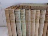 several old books are stacked on top of each other on a table
