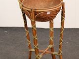 a wicker basket on a stand on the floor