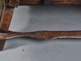 a wooden bench with a wooden handle on it
