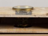 a small wooden box with a candle inside of it