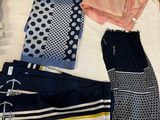 many different types of clothing laid out on a bed