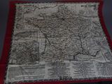 une vieille carte de la France posée sur une table, avec une bordure rouge
