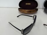 pair of black sunglasses sitting on top of a table next to a pair of glasses