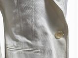 a close up of a white jacket with buttons on a mannequin mannequin mannequin mannequin mannequin mannequin mann