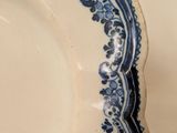 a blue and white plate on a white table