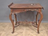 a small wooden table with a drawer on top of it