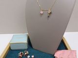 necklace, bracelet, ring, earrings, and jewelry displayed in a display case