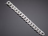 a silver chain bracelet with a clasp on a black background