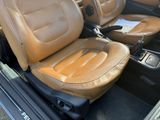 beige leather seats in the back of a car in a parking lot