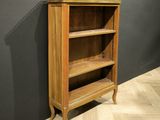 an image of a wooden bookcase against a black wall