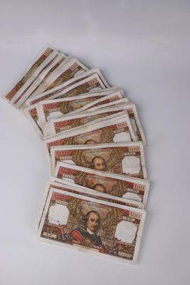 five bills of mexican currency laid out on a white surface