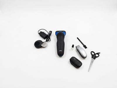 a black and white photo of a remote control and a pair of scissors