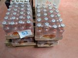 several bottles of water are stacked on a pallet with a price tag