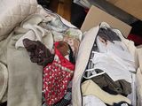 a suitcase full of clothes sitting on the floor next to a box
