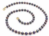 a black pearl necklace and bracelet set with a gold clasp