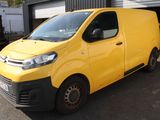 the yellow van is parked in front of a building