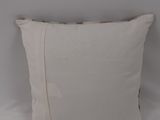 the white pillow is on a white bed with a white wall
