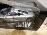 a silver toy car in a box on a table