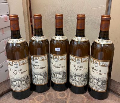 six bottles of wine are lined up on a table
