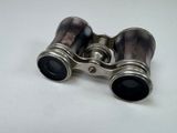 an old pair of binoculars sitting on top of a white table