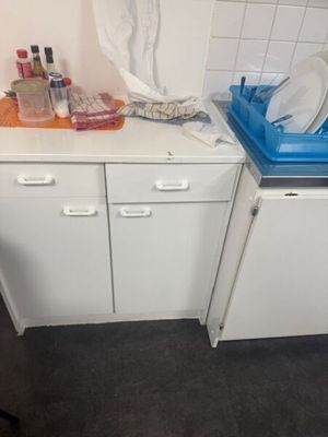 a kitchen with a sink and a dishwasher in it