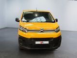 yellow citrole van parked in a showroom with white walls