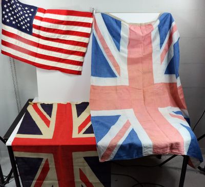 two british and american flags on a table in a room