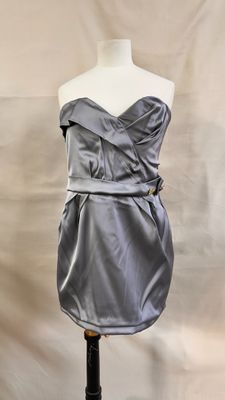 the dress is on a mannequin stand and ready to be worn