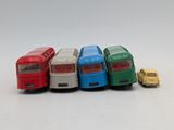 several toy cars are lined up in a row on a white surface