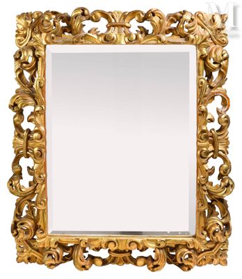 an ornate gold mirror with a white background and a gold frame
