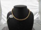 a black mannequin with a gold chain on it