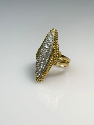 a close up of a gold ring with diamonds on a white surface