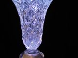 a glass vase that is sitting on top of a table