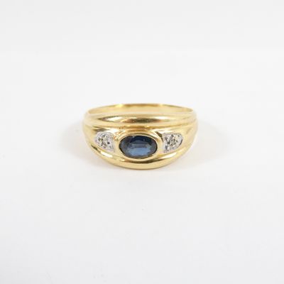a yellow gold ring with a sapphire and diamonds